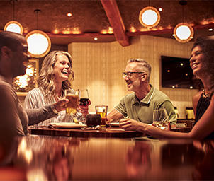 Four people with drinks at Urban Table
